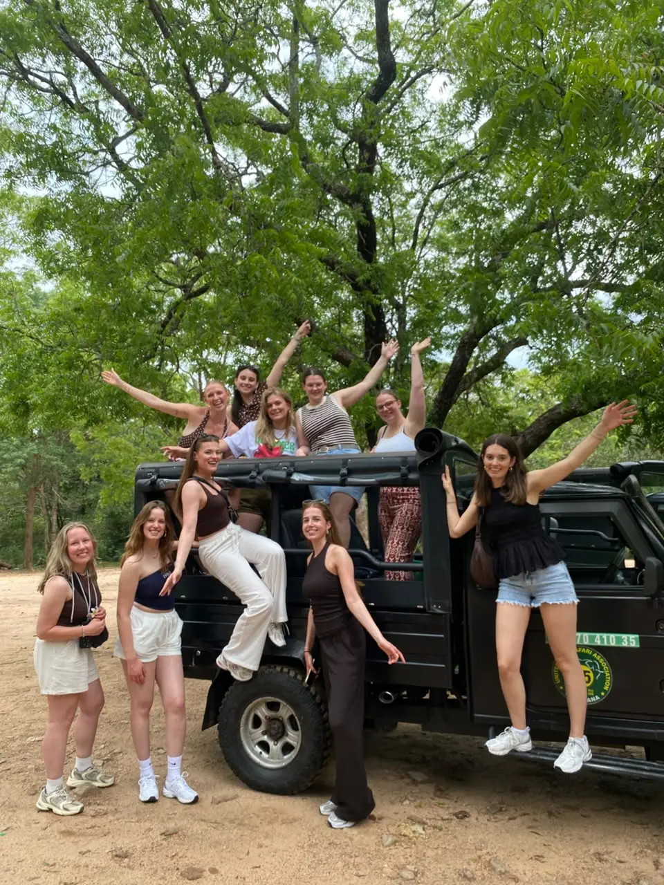 Guests standing by a safari jeep in Sri Lanka